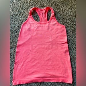 LULULEMON bright orange swiftly tank top.